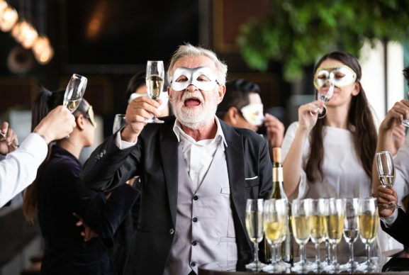 Group of office worker in fancy mask having celebration party.